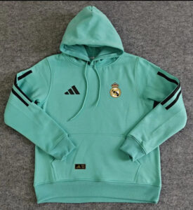 95502f81-5020-4bc0-865d-eec3ad6cba9d | UAE SPORT STORE Mint green Real Madrid hoodie with hood, Adidas logo on left chest and the club crest on the right; black stripe accents on sleeves.