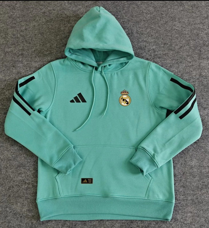 95502f81-5020-4bc0-865d-eec3ad6cba9d | UAE SPORT STORE Mint green Real Madrid hoodie with hood, Adidas logo on left chest and the club crest on the right; black stripe accents on sleeves.