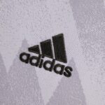 Close-up of lavender towel fabric with dark embroidered lettering partially visible.