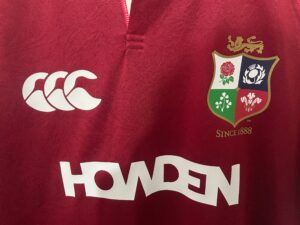 95f2d24f | UAE SPORT STORE Maroon rugby jersey featuring the Canterbury logo on the left and a team crest with four quadrants and a gold lion above. Mention of 'Since 1888' appears nearby.