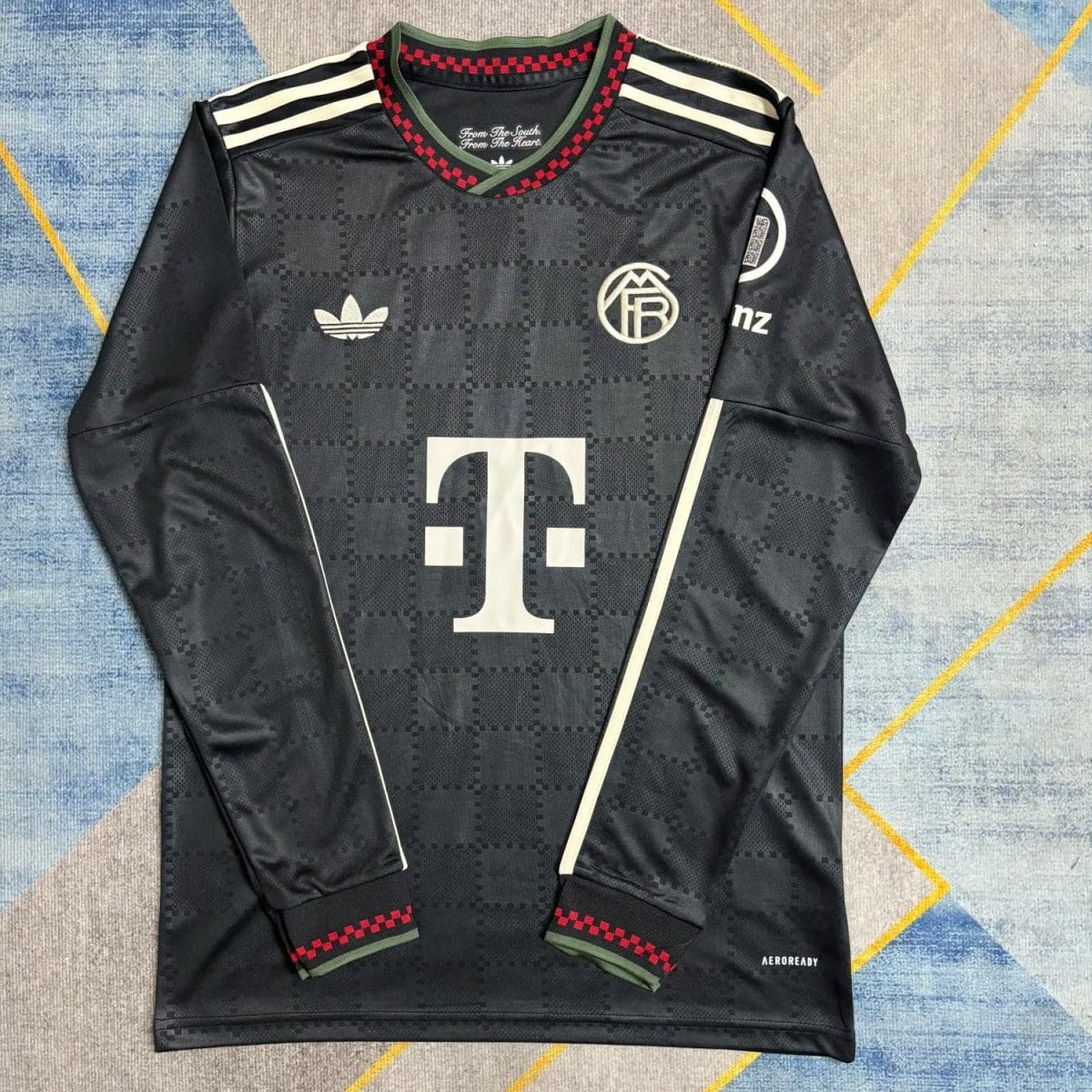 Black Adidas football jersey with a dark checkerboard pattern, white stripes on the shoulders, and a large white 'T' logo on the front. Crest badge on the left chest and Adidas trefoil on the right; red-green ribbed collar and cuffs; 'AEROREADY' text near the bottom hem.