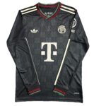 Black Adidas soccer jersey with a subtle checkered pattern, club crest on the chest, large T‑Mobile sponsor logo, and red/green cuff detail on sleeves.