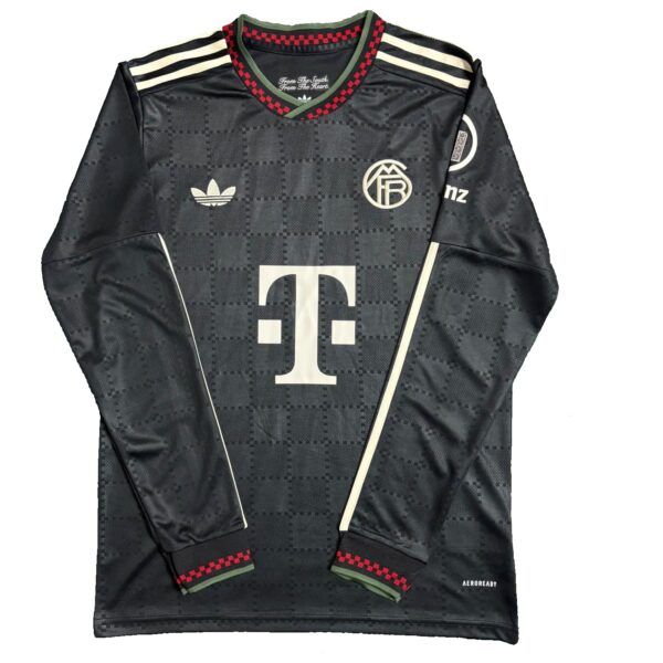 Black Adidas soccer jersey with a subtle checkered pattern, club crest on the chest, large T‑Mobile sponsor logo, and red/green cuff detail on sleeves.