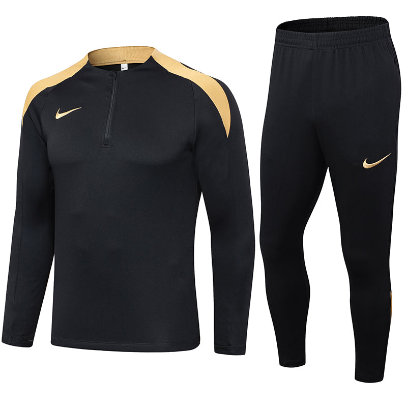 96e41a71 Black Nike athletic long-sleeve top with gold shoulder panels and matching black jogger pants featuring gold swoosh logos — a matching training set.