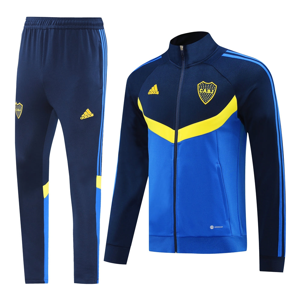 9841a965 | UAE SPORT STORE Blue and royal blue tracksuit set: zipper jacket with yellow chevron and club crest, matching pants with Adidas stripe details along the sides.