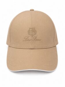 98470ddc-e223-46c5-a5cb-9f860ced1ac8 | UAE SPORT STORE Beige baseball cap with an embroidered crest and Loro Piana logo on the front panel.