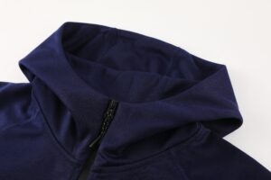 Close-up of a navy blue jacket collar with a black zipper and visible stitching, showing the fabric texture and seam details.