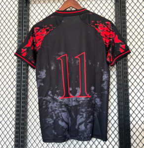 Back view of a black athletic jersey with red shoulder accents and a large red '11' on the back, hanging on a wooden hanger against a metal rack wall.
