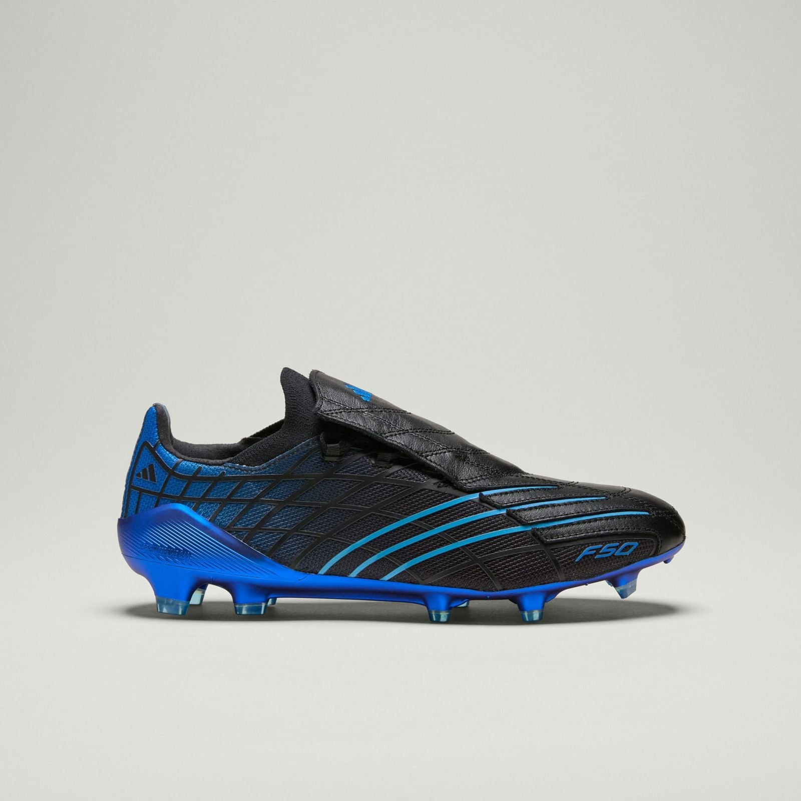 991bb67b-b9fd-46d8-8cb9-f86dd8d7ee08 | UAE SPORT STORE Blue and black soccer cleat with blue studs, side view showing textured upper and blue sole.