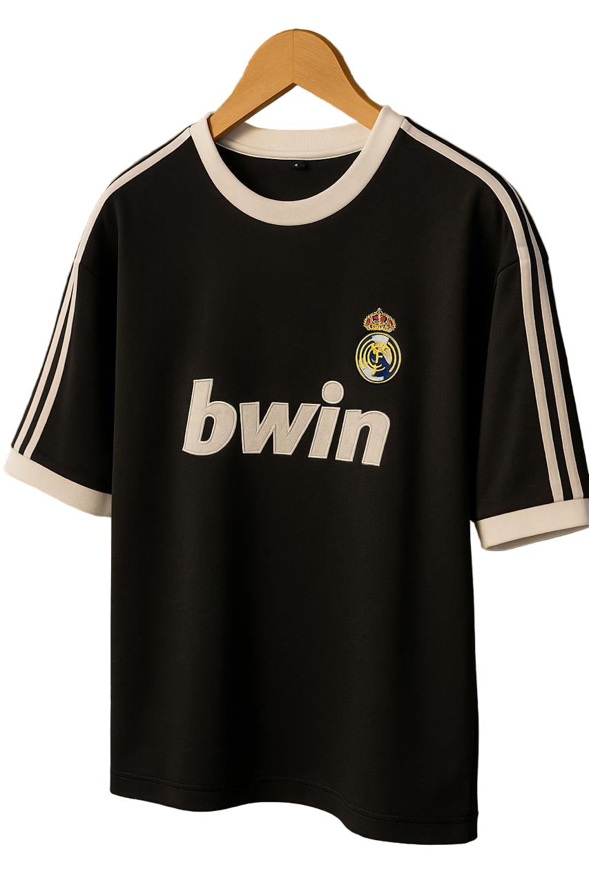 Black Real Madrid soccer jersey on a wooden hanger with white trim and the 'bwin' sponsor logo visible on the front.