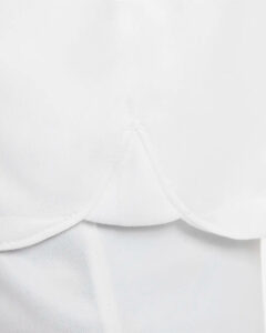 Close-up of white fabric with curved seam folds and soft texture.