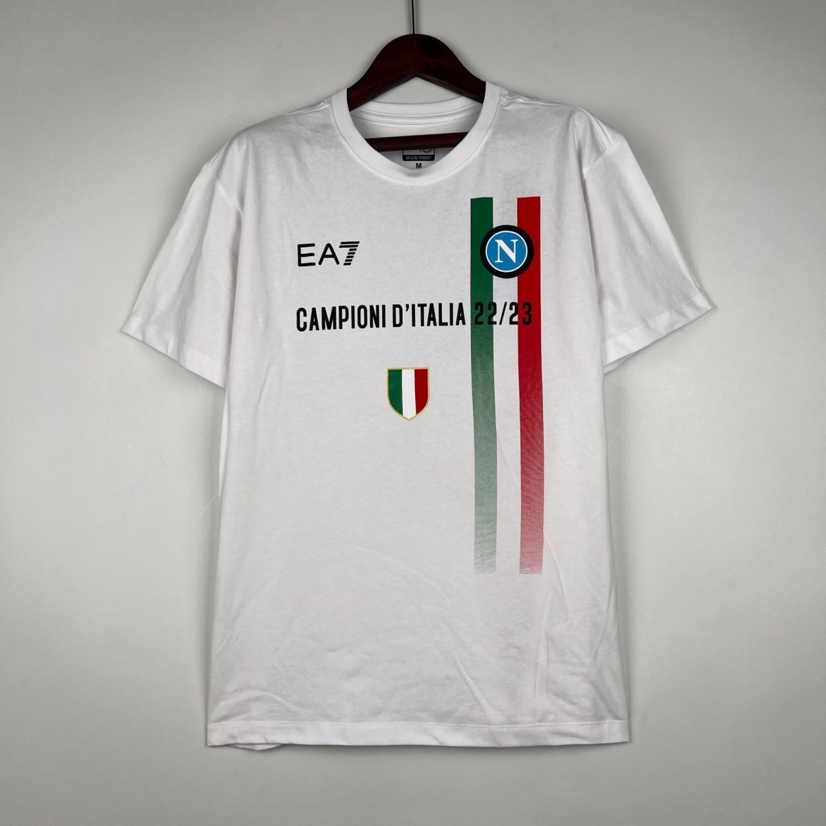 White T-shirt on a hanger featuring vertical green, white, red stripes with a Napoli crest and the text 'CAMPIONI D'ITALIA 22/23'.