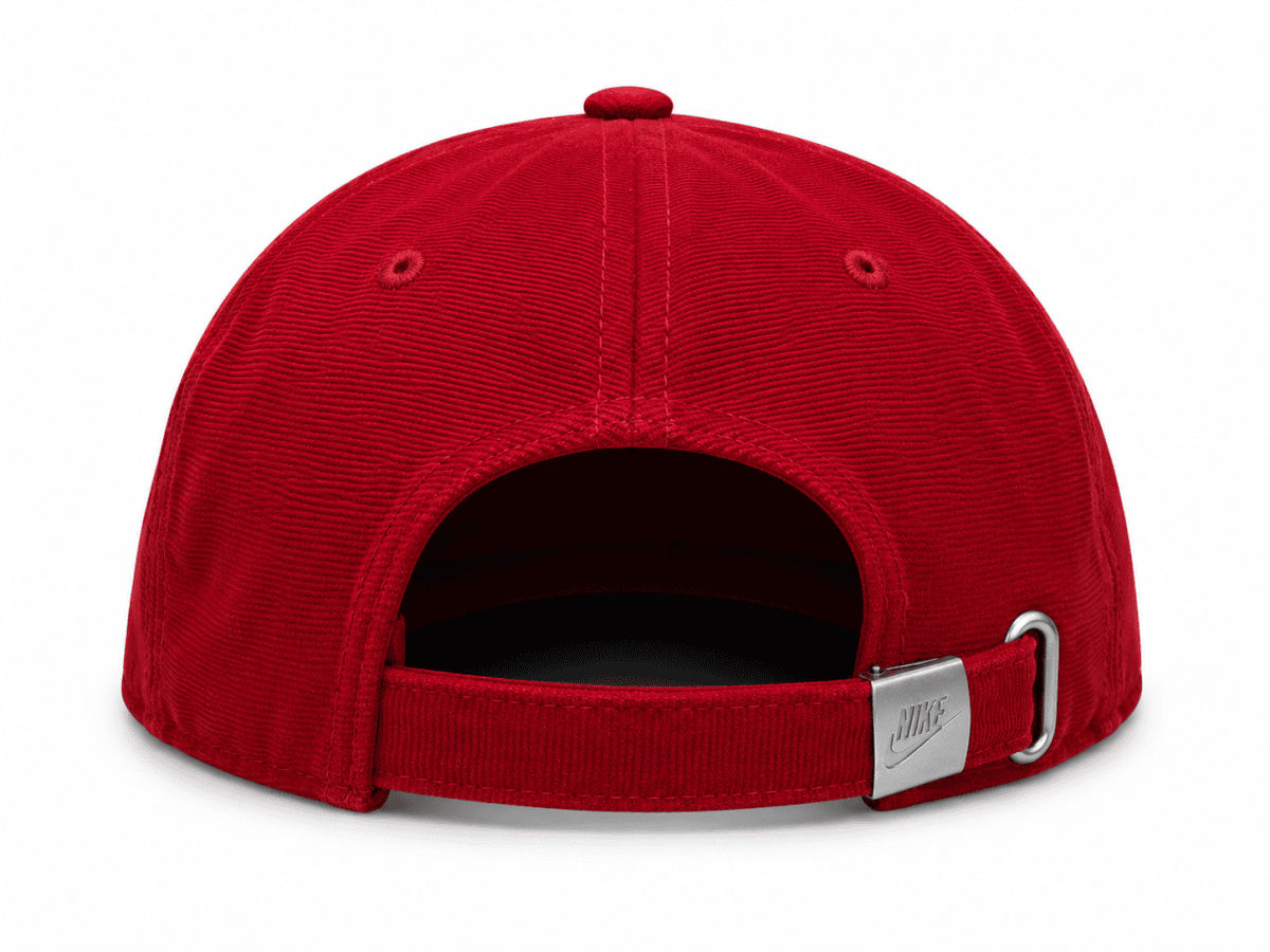 Back view of a red baseball cap with an adjustable strap and metal buckle displaying the Nike logo.