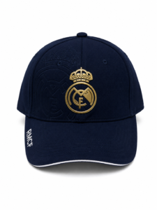 Navy baseball cap with a gold Real Madrid crest centered on the front and white trim along the brim.