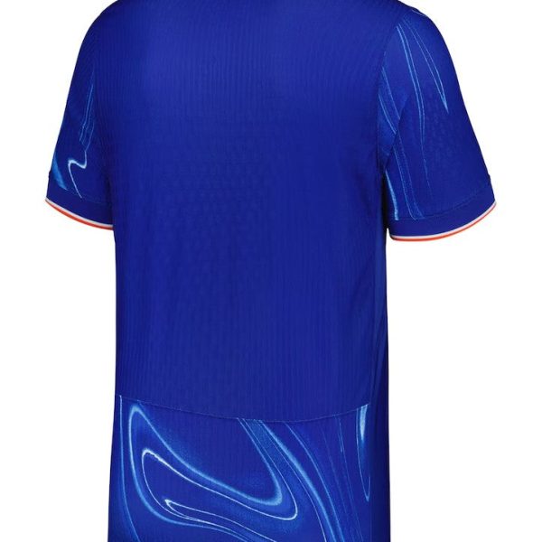 Back view of a royal blue athletic jersey with a swirling lighter blue pattern at the hem and red-trimmed sleeves.