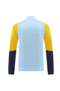 Back view of color-blocked long-sleeve sports shirt: light blue body, yellow shoulders, navy sleeves