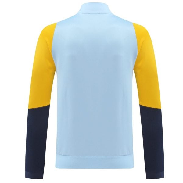Back view of color-blocked long-sleeve sports shirt: light blue body, yellow shoulders, navy sleeves