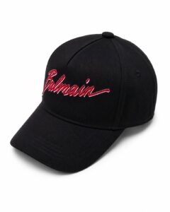 Black baseball cap with red embroidered 'Balmain' script on the front panel
