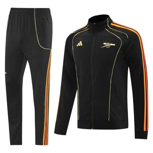 Black athletic tracksuit jacket with yellow piping and orange side stripes, matching black pants with similar stripes; features Adidas logo and Arsenal crest, suitable for training or casual wear.
