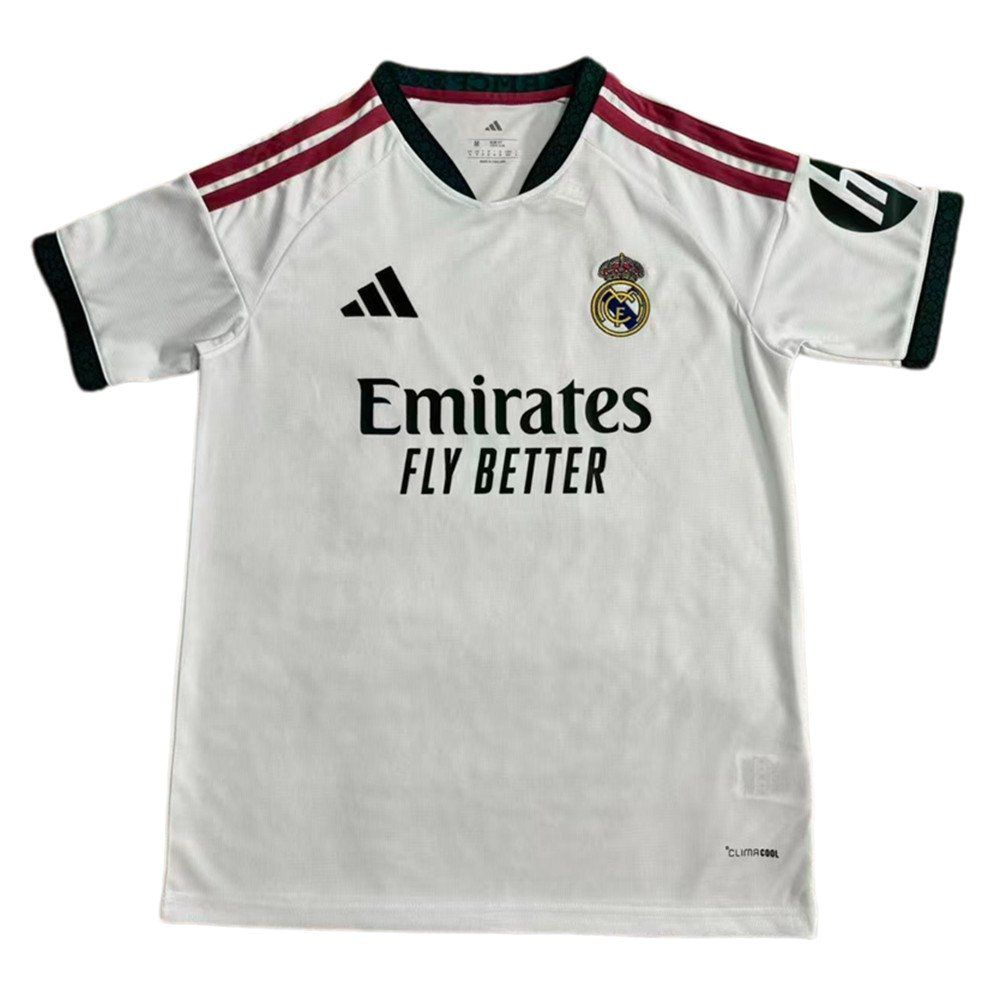 9bacda66-c24c-44ed-b652-38e9dc20b84d | UAE SPORT STORE White Real Madrid football jersey featuring the crest, Adidas logo, maroon shoulder stripes, and the sponsor 'Emirates Fly Better'.
