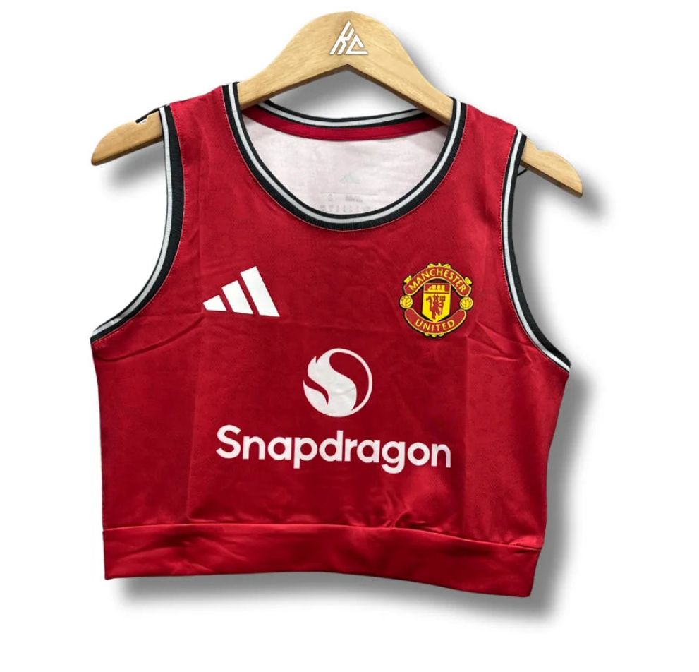 Red Manchester United basketball jersey on a wooden hanger with Adidas logo and Snapdragon sponsor.