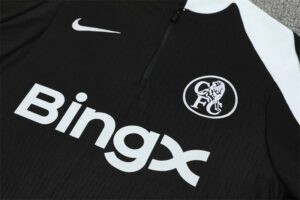 Black soccer jersey with white sponsor text 'BingX', Nike swoosh, and a circular club crest on the chest.