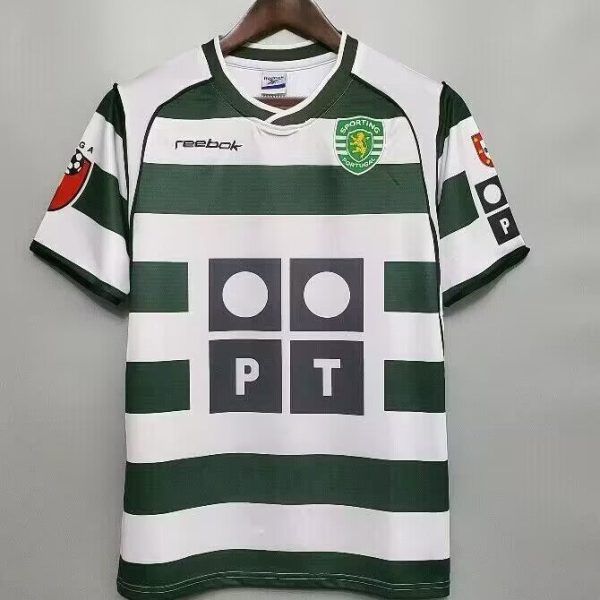 Front view of Sporting CP green-and-white hoop jersey on a hanger, with Reebok logo and sponsor panels visible on chest and sleeves.