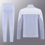 9d9613b3 | UAE SPORT STORE Two-piece pale blue tracksuit with white shoulder panels; jacket shown from the back and matching pants.