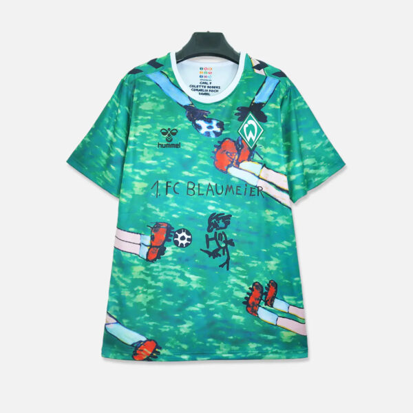 Green camouflage-style soccer jersey with Werder Bremen crest, Hummel logo, and a playful cartoon legs illustration across the front.