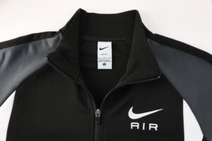 Nike black and gray zip-up jacket with a white swoosh and AIR on the left chest area, zipper partially open at the collar.