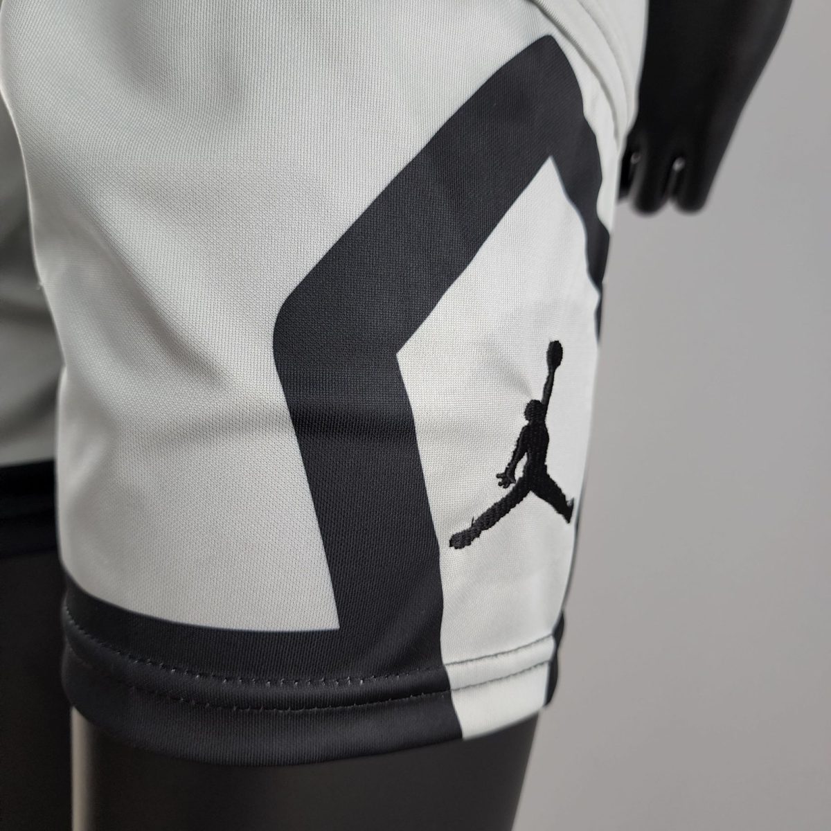 Close-up of white fabric with a bold black diagonal stripe design.