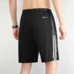 Back view of a person wearing black athletic shorts with white three-stripe side detailing and an Aeroready logo near the waistband.