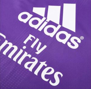 Purple background with a white Adidas logo and partial text, representing the Adidas brand graphic.