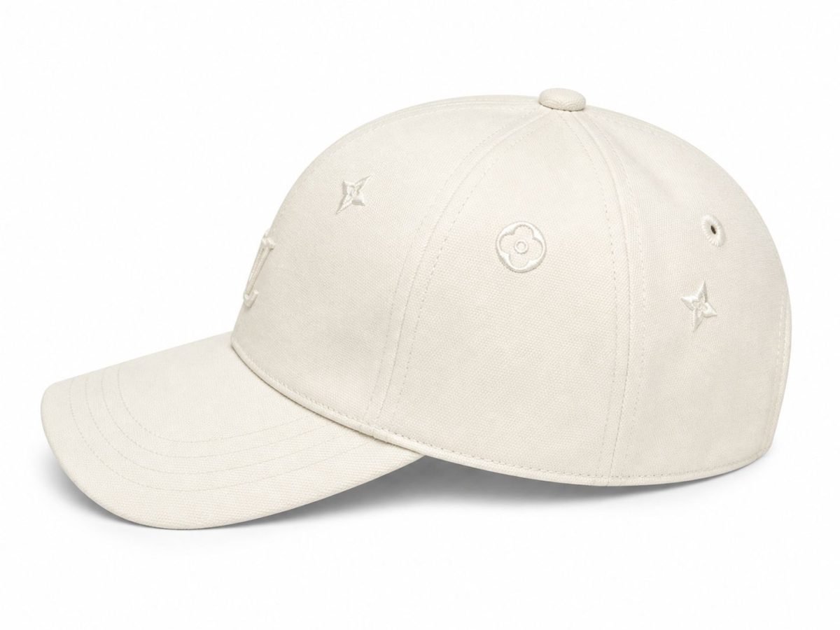 Beige baseball cap with small embroidered flower and star motifs on the front panels.
