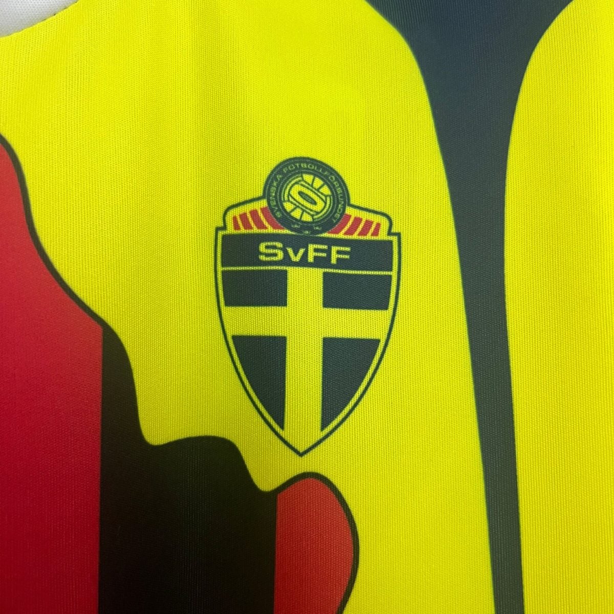 Close-up of a neon yellow high-visibility safety vest with a circular chest badge.