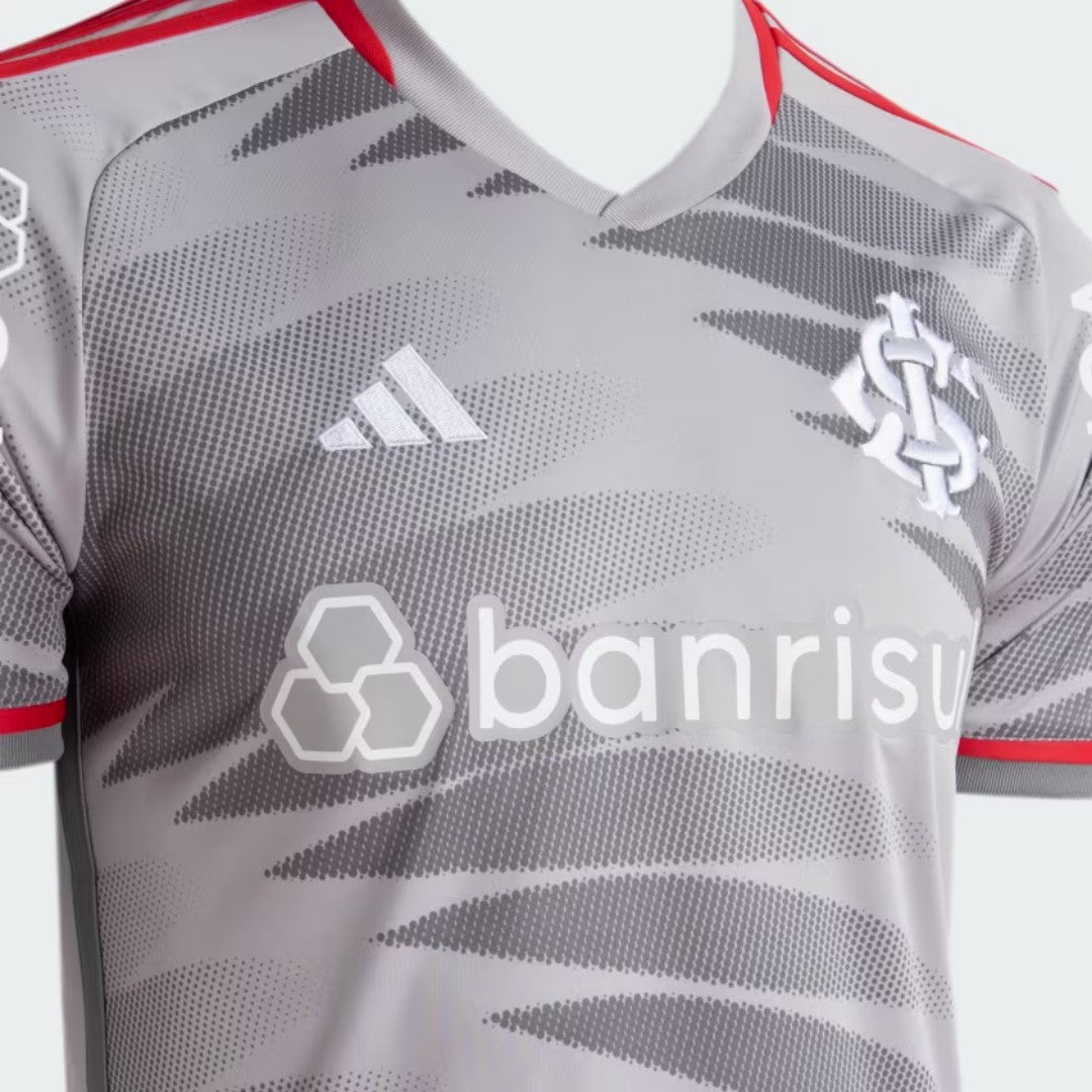 9nOIYyHmtIohlYg | UAE SPORT STORE Gray camouflage-pattern sports jersey with red trim, featuring Adidas logo and a club crest on the chest, and 'banrisul' sponsor text across the front.