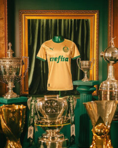 Palmeiras home jersey on a display mannequin surrounded by ornate trophies and green drapery in a museum-like setup.