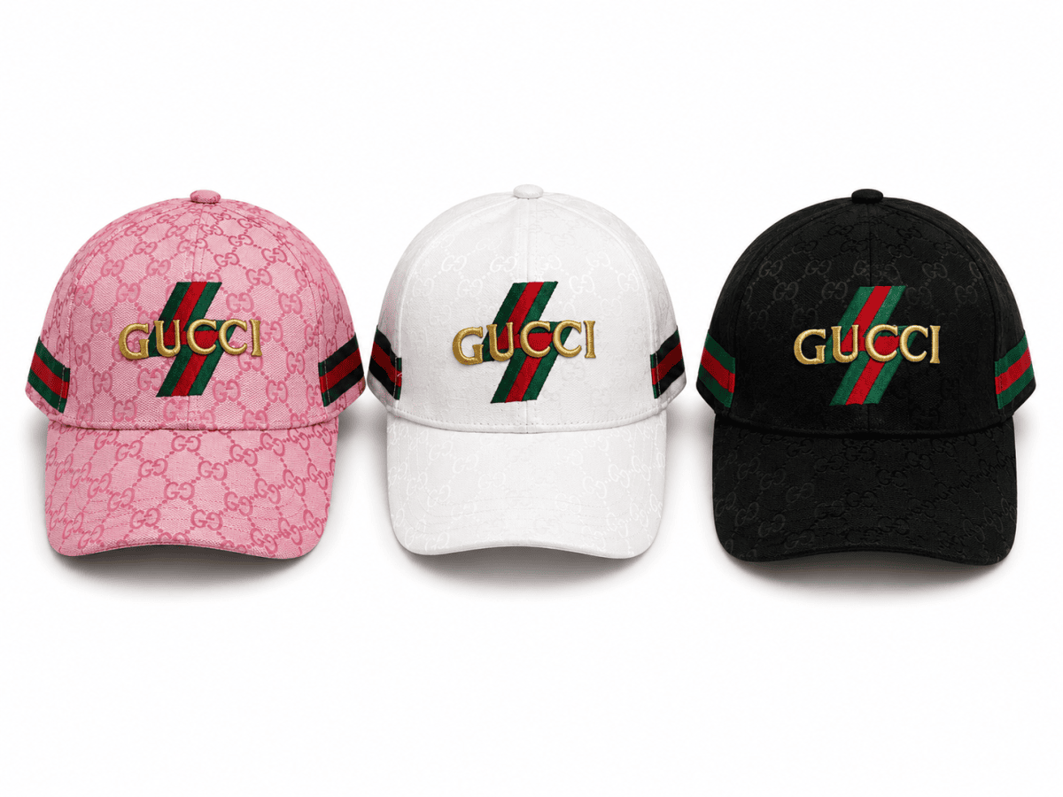 Three Gucci baseball caps in pink, white, and black, each featuring a gold Gucci logo and the signature red‑green stripe over a repeating GG pattern.
