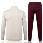 Beige long-sleeve pullover with ribbed cuffs and hem, paired with burgundy jogger pants as a sportswear set.