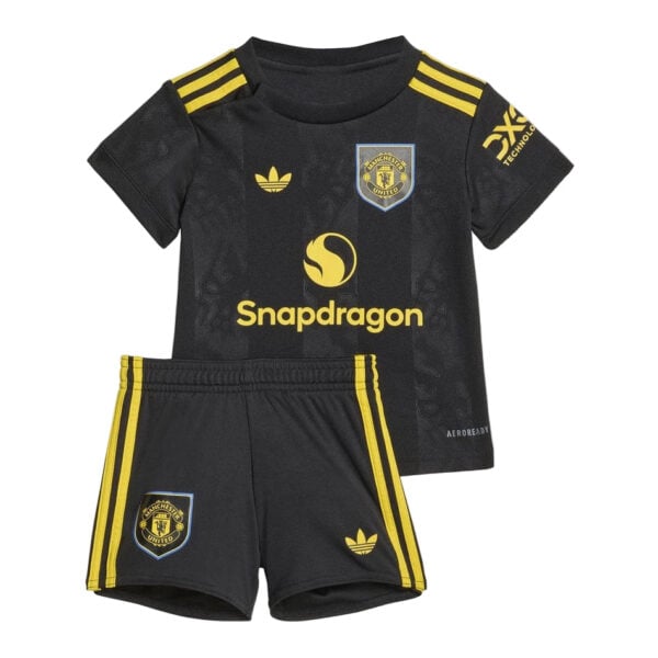 Kid-sized black Manchester United soccer kit with yellow accents: jersey featuring Snapdragon sponsor logo and club crest, paired with matching shorts with side stripes and crest