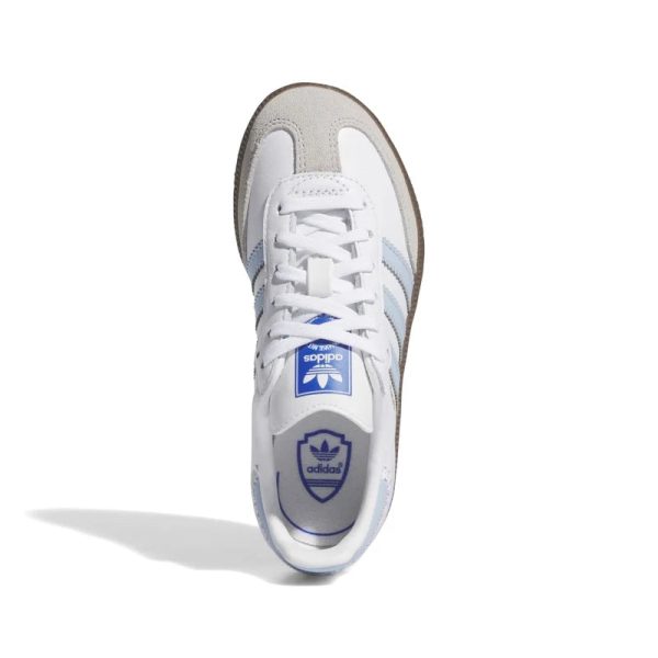 Top-down view of a white Adidas sneaker with light blue stripes and laces tied, logo on the tongue visible.