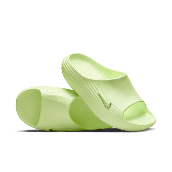 Light-green slide sandals with a textured strap and Nike swoosh on a white background.