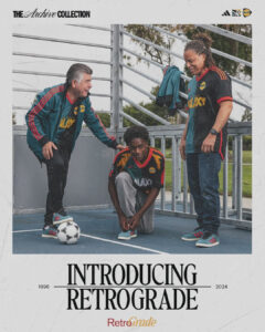 AfGVdJyYGetsATQ | UAE SPORT STORE Three people in matching Galaxy soccer jerseys chat on a small outdoor court, one kneeling to tie shoes by a soccer ball as the other two smile.