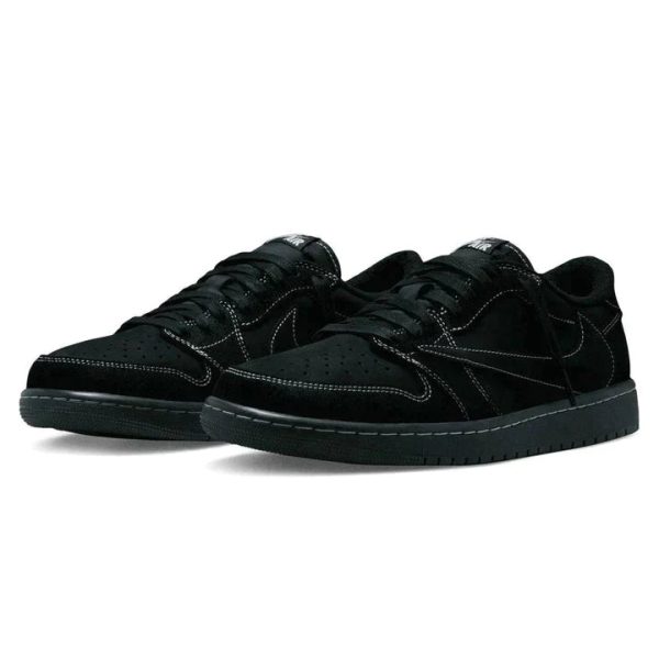 Pair of black suede sneakers with white stitching and a black sole laid side by side on a white background