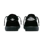 Pair of black sneakers viewed from the back, each with a white embroidered logo on the heel.