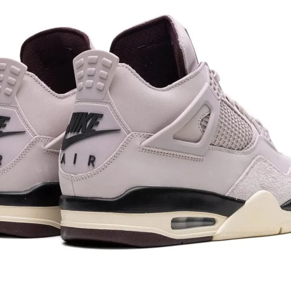 Pair of light gray Nike Air sneakers shown from the back-right, highlighting the heel logo and sole