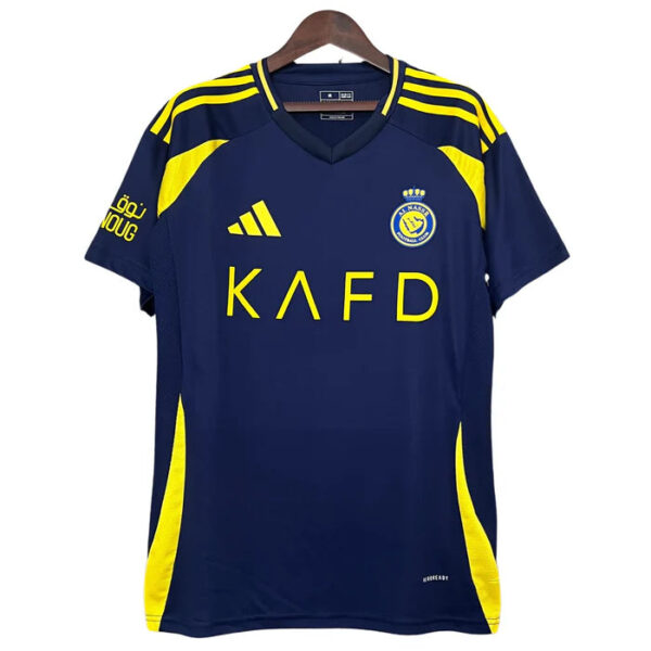 Navy blue soccer jersey with bright yellow panels, Adidas logo and crest on the chest, sponsor text 'KAFD' across front, hanging on a hanger.