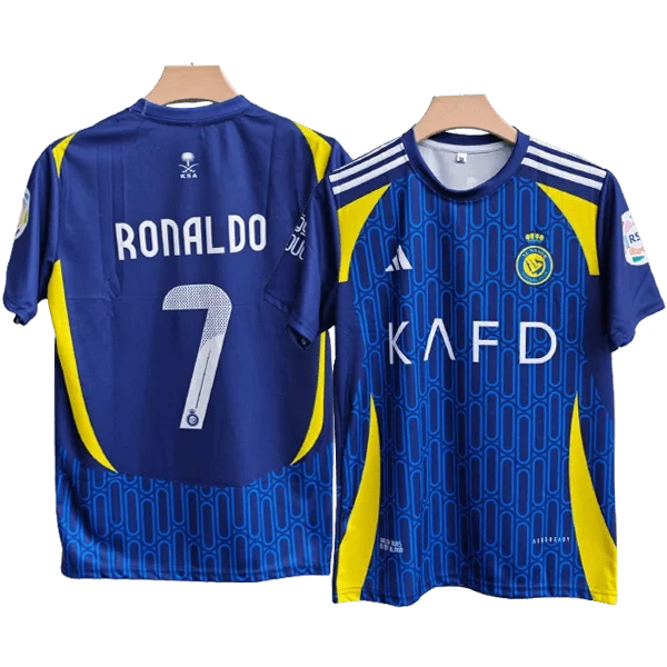 Two blue soccer jerseys with yellow panels, shown from front and back; left jersey features 'RONALDO' and the number 7 on the back, right jersey shows a club crest and the letters 'KAFD' on the front.