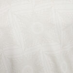 Soft beige geometric wallpaper pattern with overlapping star-like shapes in a subtle, textured design.