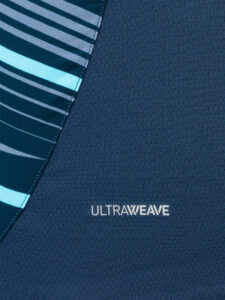 Close-up of dark blue UltraWeave fabric with a diagonal teal-striped panel on the left.